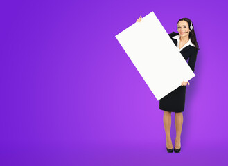 Call Center Service. Customer support or sales agent. Businesswoman or caller or phone operator hold banner with copy space. Full body of business woman with white signboard. Violet color background.