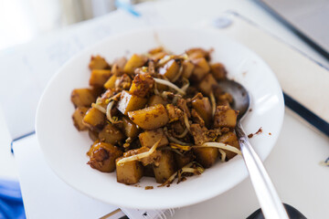 Home cook “Char Koay Kaka” Fried rice cake in square shape on a white plate