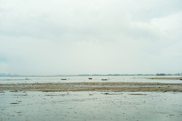 Natural scene of parking wooden boats on the coast with seascape and sky background