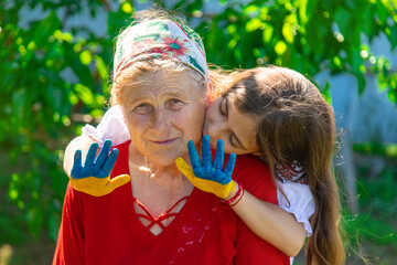 Child and grandmother hand drawn flag of Ukraine. Selective focus.
