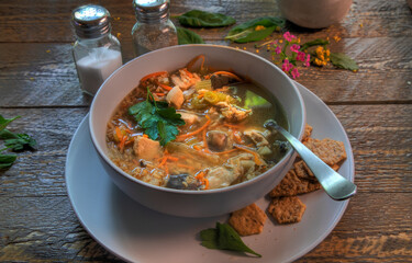 Side View Of Chicken and Rice Soup on natural wood surface.