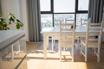 stylish apartment design with panoramic windows with a table and chairs