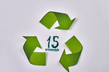 Obraz premium 15 november national recycling day concept. Green recycling symbol. Isolated on white background.