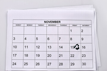 November calendar with marked 15 day on white background. Recycling day concept.