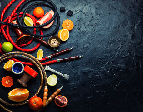 Smoking hookah with citrus fruits.