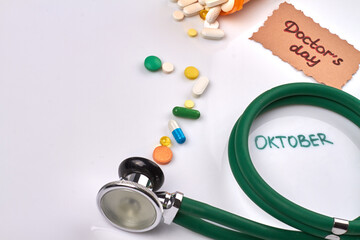 Close-up stethoscope and various tablet pills on white background. Doctors day concept.