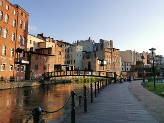 The old town houses with footbridge over Mlynowka river and Mill Island boardwalk alley, Bydgoszcz, Poland