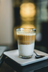 Cup of dirty coffee mixing lungo shot with cold milk.