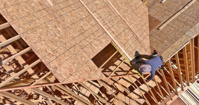 Aerial view of a roof rafters with wooden plywood panels sheating in new house