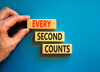 Every second counts symbol. Concept words Every second counts on wooden blocks on a beautiful blue table blue background. Businessman hand. Business, motivational and every second counts concept.