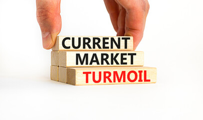 Current market turmoil symbol. Concept words Current market turmoil on wooden blocks on a beautiful white table white background. Businessman hand. Business, finacial current market turmoil concept.