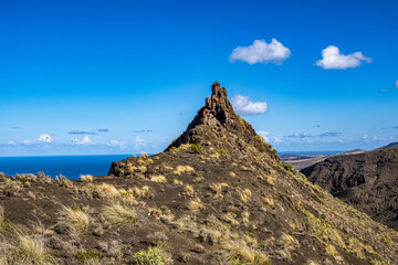 Fototapeta na wymiar The finger of god, rock formation on the coast of Agaete, Roque Guayedra, Gran Canaria, Spain