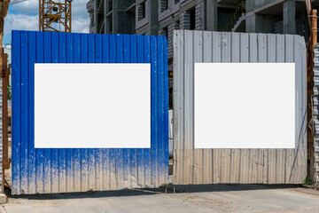 Dual blank sign boards mounted on gate at construction site. Mockup for design and information. © Bonsales