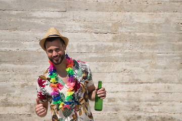 Young and handsome man, blue eyes, perfect smile, with beard, hat, Hawaiian shirt and flower...
