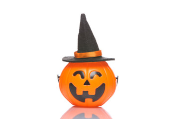 Halloween candy bucket with jack pumpkin face and witch hat isolated on white background with shadow