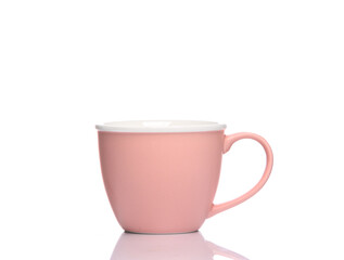 Pink ceramic cup isolated on white background with reflection