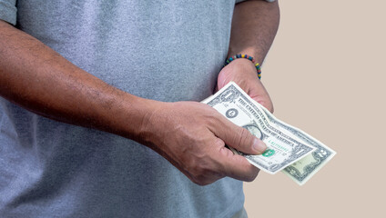 Man counting dollars in hands to pay, close up