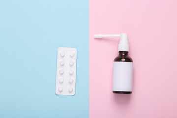 Mockup Throat spray with white empty labels and white blister of pills on blue pink background.