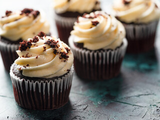 Chocolate cupcakes with whipped cream topped with grated chocolate. Lots of objects. Holiday, birthday, banquet. Restaurant, hotel, cafe, pastry shop, home cooking, recipe book.