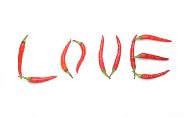 Word love made from red chili peppers isolated on white background