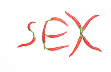 Word sex made from red chili peppers isolated on white background. Romantic love concept