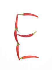 Letter E made from red chilli peppers isolated on white background