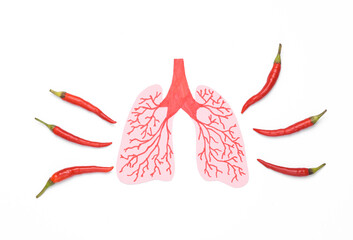 Illness, pain in the lungs. light anatomical with chili peppers on white background