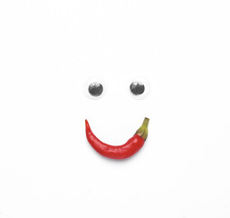 Face made of goggle eyes and chili peppers on white background