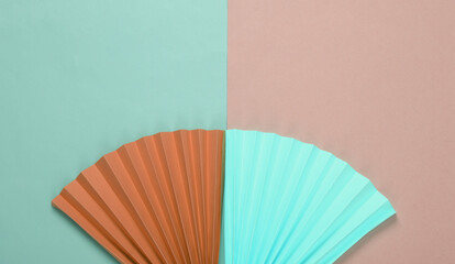 Paper fans on blue-pink pastel background. Concept art, minimalism