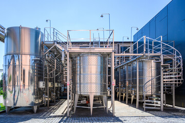 Wine steel tanks, equipment of contemporary winemaker factory.  Barrels for wine storage. Equipment for the fermentation, distillation of alcohol. Preparation workshop for pure alcohols.
