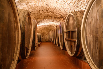 Vintage winery cellar with wine wooden barrels