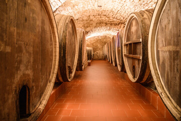 Vintage winery cellar with wine wooden barrels