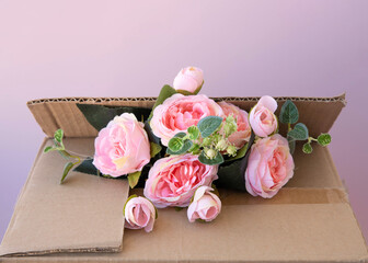 In a brown cardboard box pink flowers eco-friendly packaging