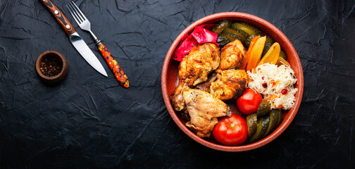 Tasty baked chicken and pickles.