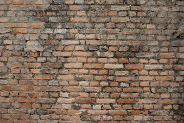 Exposed brick texture. Wall built with blocks. Construction, photo background, backdrop. Orange brick, old red. Old construction.