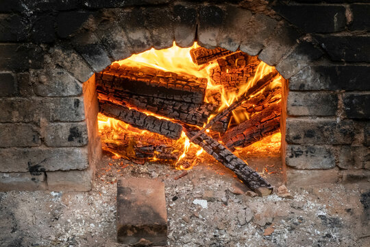 Firing of wood fire kiln is part of process for black pottery. Unique handmade pots and dishes of clay getting black after firing and oxygen reducing process in wood fire kiln. Latvian national crafts