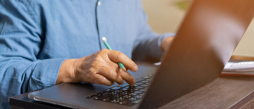 Close Up On Mature Woman Work On Laptop For Making Expense Monthly And Manage Spending Of Life When Retire Such As Home Loan,insurance,savings,travel,health , Lifestyle Aged People Concept