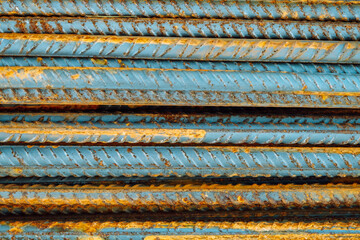 Metal fittings for reinforced concrete. Main construction materials. Background and rusty iron reinforcement rods. Red orange color of iron oxide on reinforcement bars