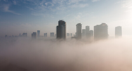 Heavy fog in Tel Aviv. Above panorama. The city over the clouds