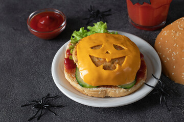 Funny monster chicken burger with toast cheese, ketchup and cucumber. Halloween food