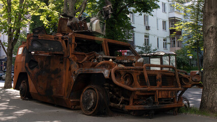 Fototapeta na wymiar Destroyed and burned Russian army armored car in Ukraine. War in Ukraine. 