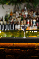 Aviation, drink with gin, lemon juice, maraschino liqueur and violet cream liqueur standing on bar counter.