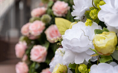 Artificial flowers in pastel colors. A bunch of artificial flowers. Ever-blooming bouquet.