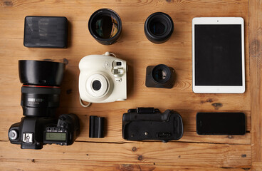 Everything you need to be a photographer. High angle shot of wireless technology and camera equipment.