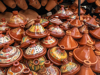 Glazed and decorated terra cotta tangines are piled up awaiting buyers in the Marrakech medina.