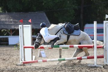 Unknown unidentified rider fall off her grey colored horse meanwhile riding in the outdoor arena....