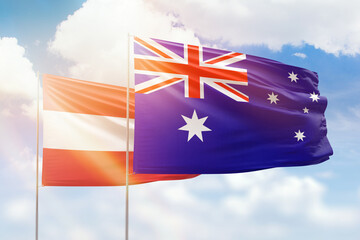 Sunny blue sky and flags of australia and austria