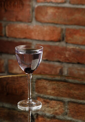 Aviation, drink with gin, lemon juice, maraschino liqueur and violet cream liqueur standing on bar counter.