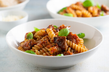 Pasta alla Norma - traditional Italian food with eggplant, tomato, cheese and basil