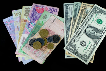 American dollar and Ukrainian hryvnia close up on a black background with space